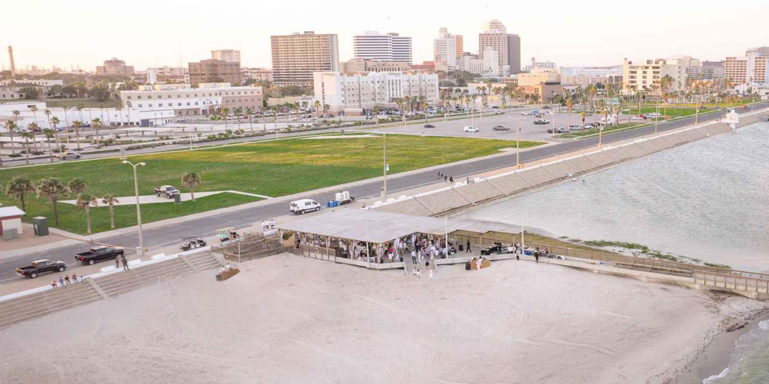 Drone photo of the seawall with the city of Corpus Christi in the background